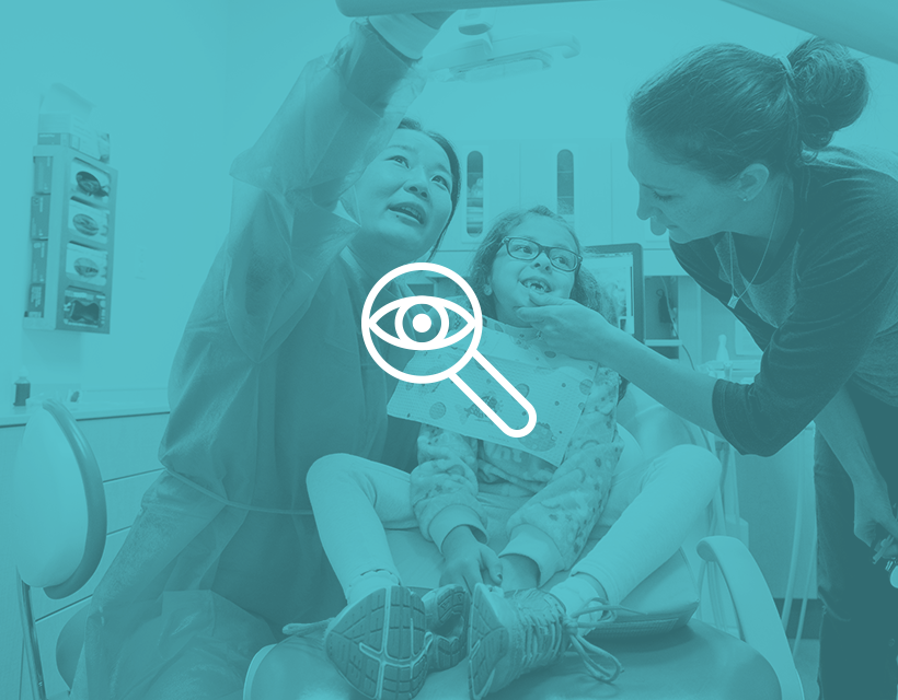 icon of an eye overlaid with a blue filter on an image of dental providers working with a child patient