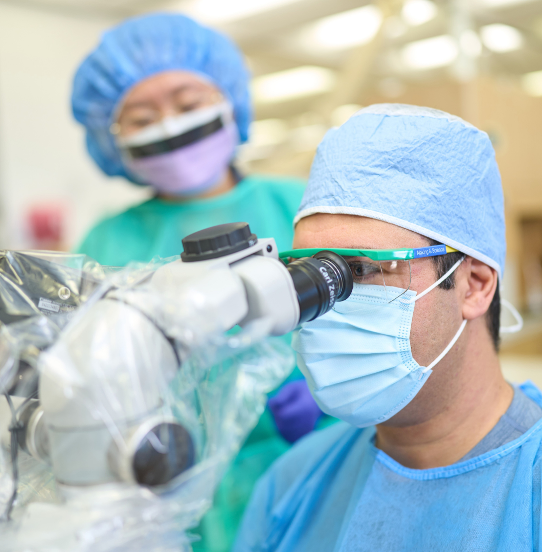 Endodontics faculty member at the microscope