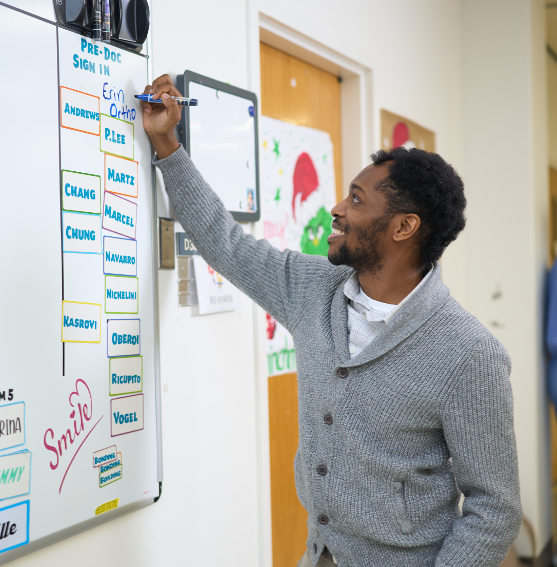 Orthodontics resident at the scheduling board.