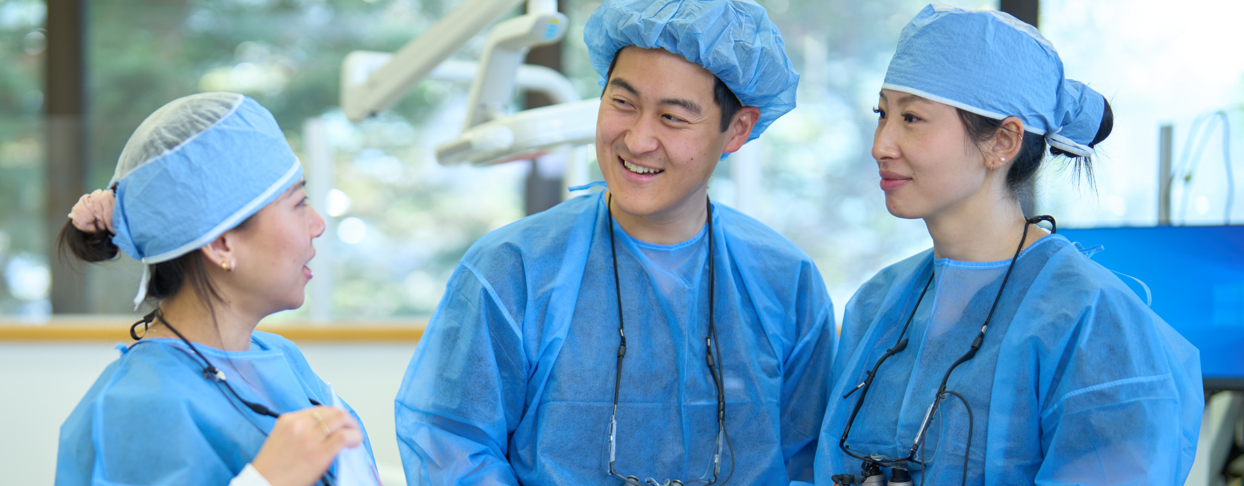 periodontics residents in conversation in the clinic