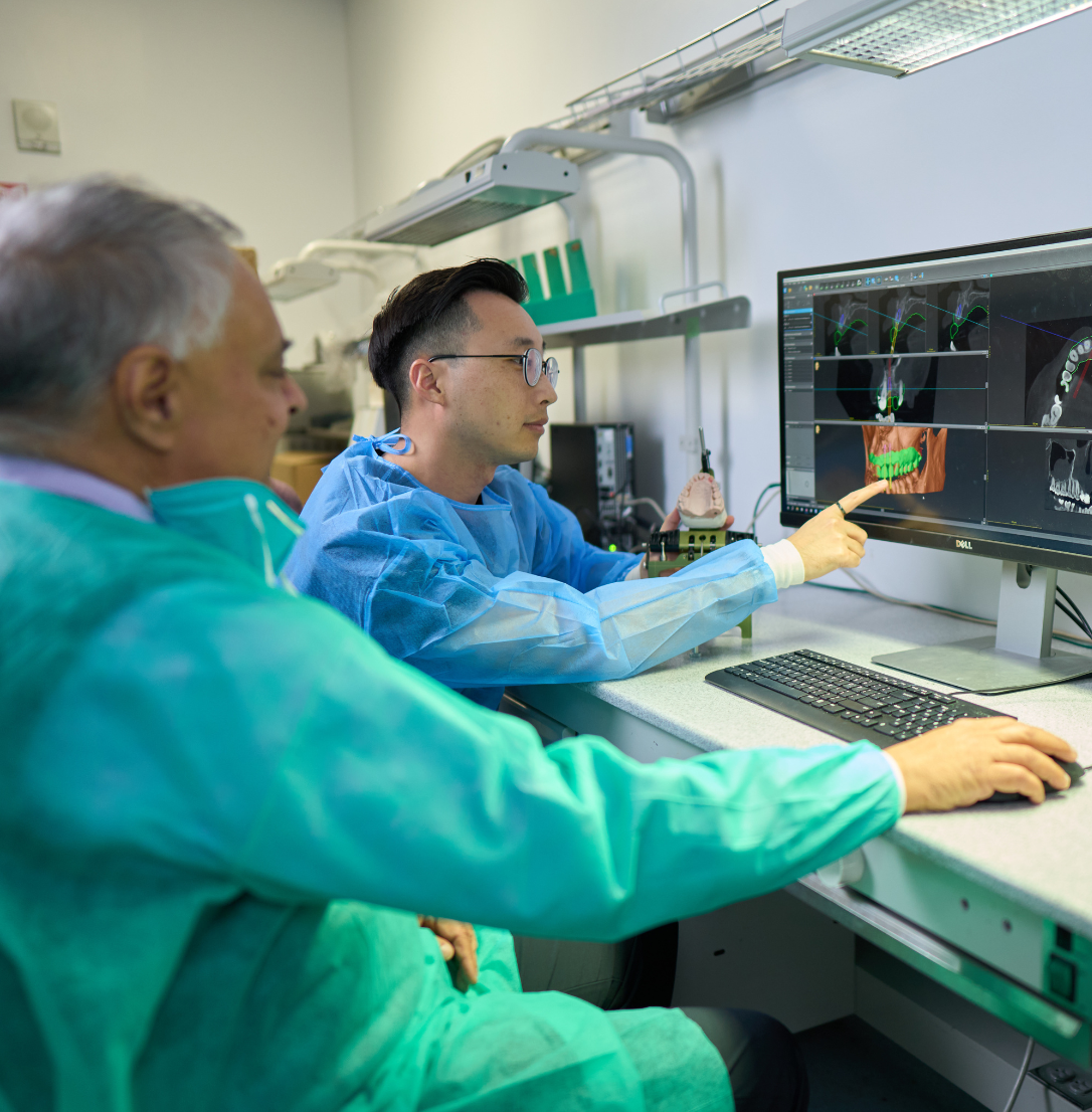 Prosthodontics faculty in conversation with a resident