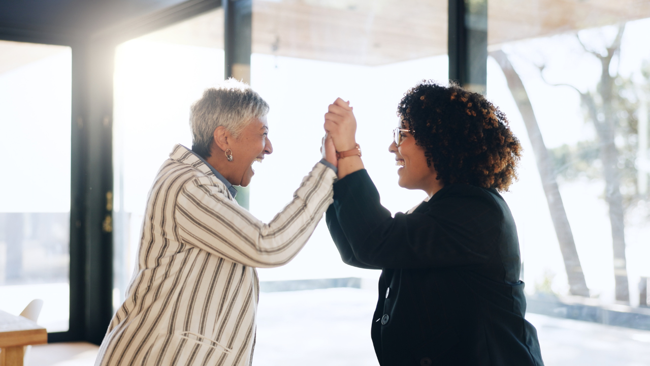 Mentor and mentee high five each other