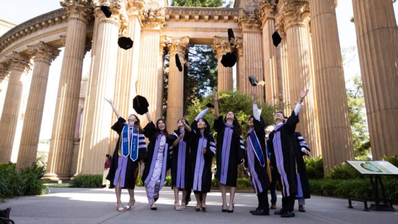 UCSF School of Dentistry graduates throw caps in the air