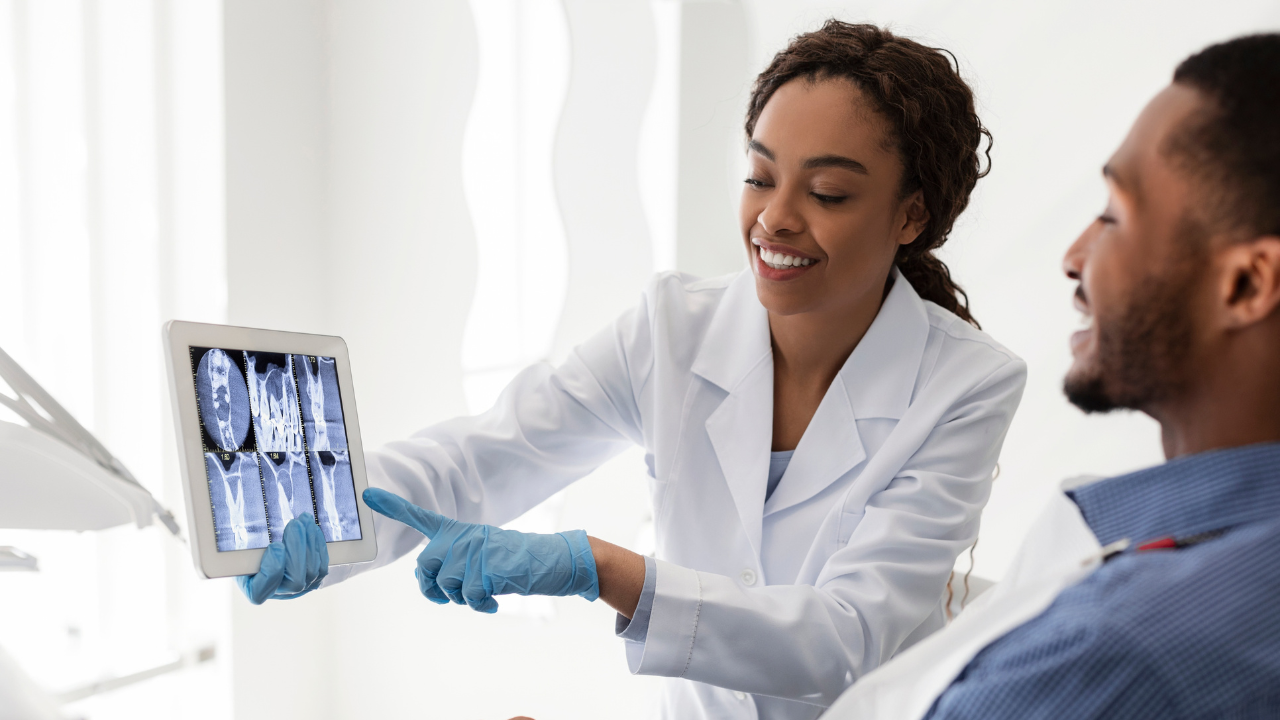 A female dental educator looks at xrays with a student