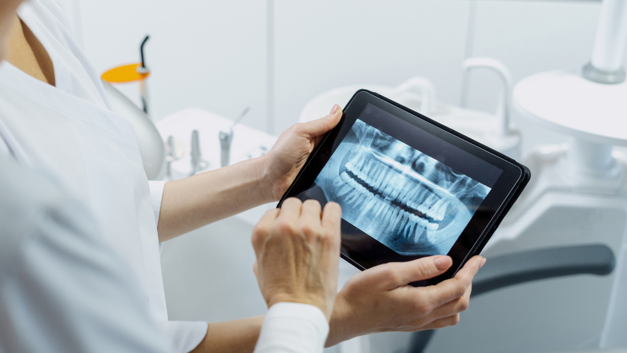 dentist looking at xrays on a tablet