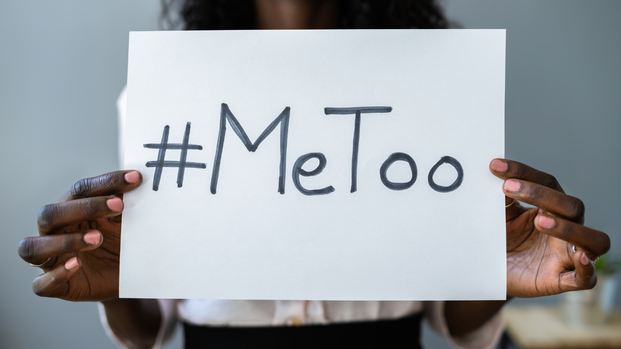 Person holding handwritten sign with #MeToo