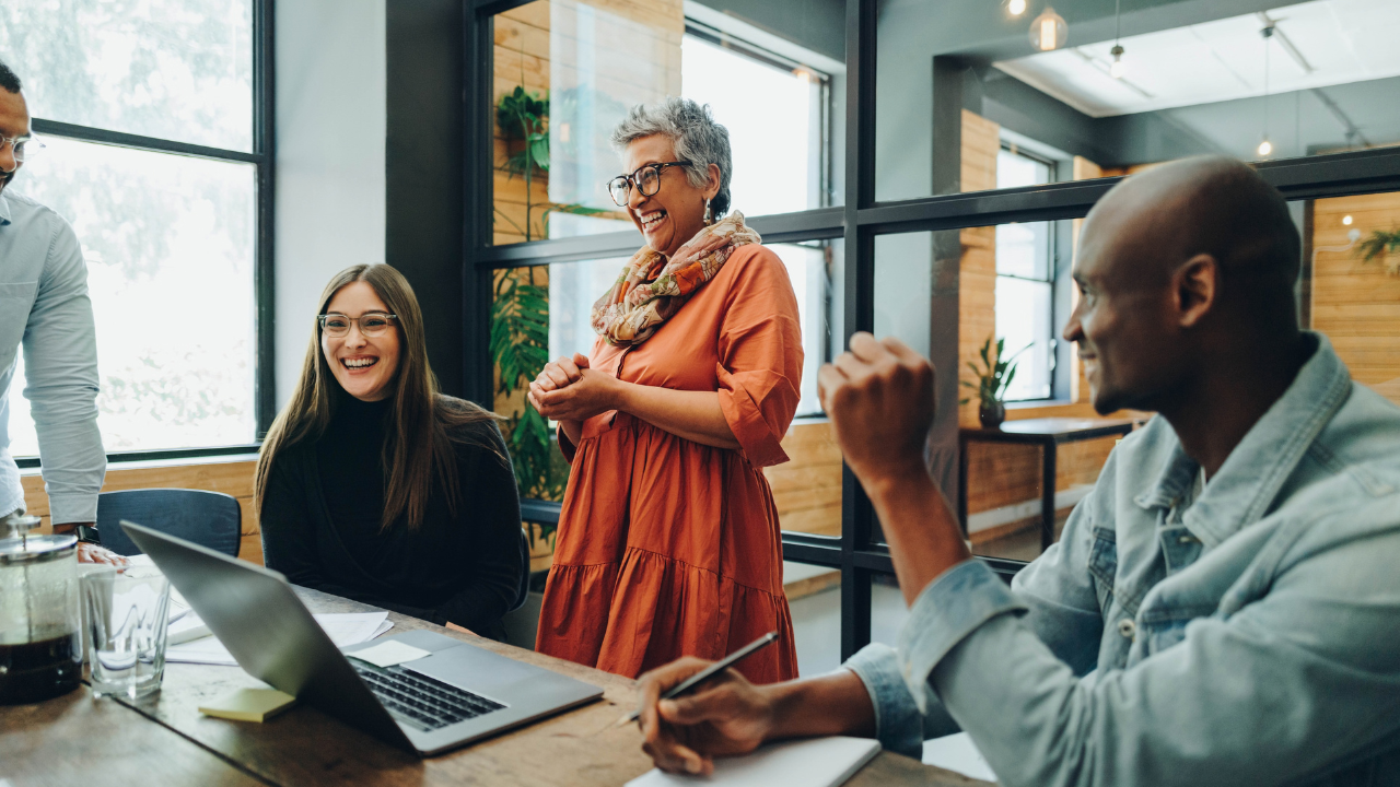 Colleagues in a work setting laughing