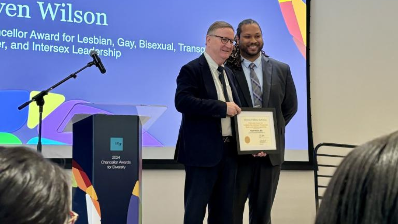 Chancellor Hawgood presents Ryen Wilson with the Chancellor Award