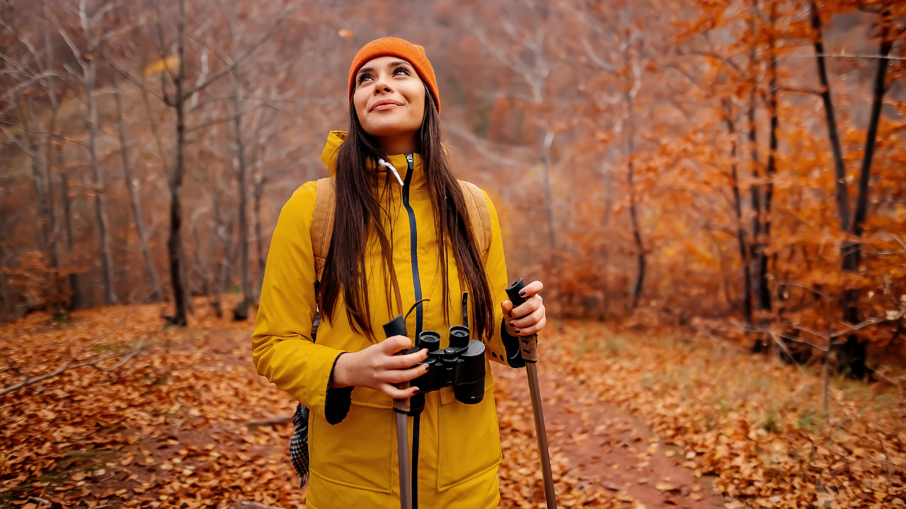 Woman in the forest of autumn leaves on a hike