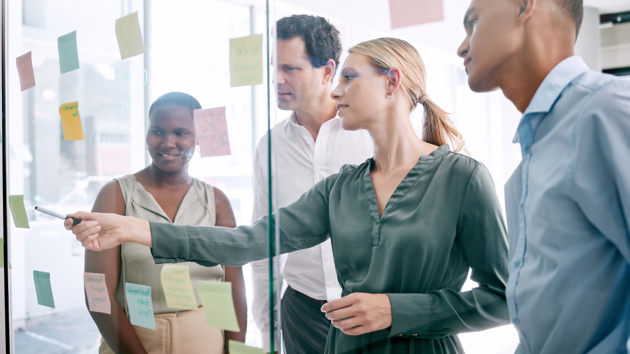 Colleagues brainstorming with post-its on the wall