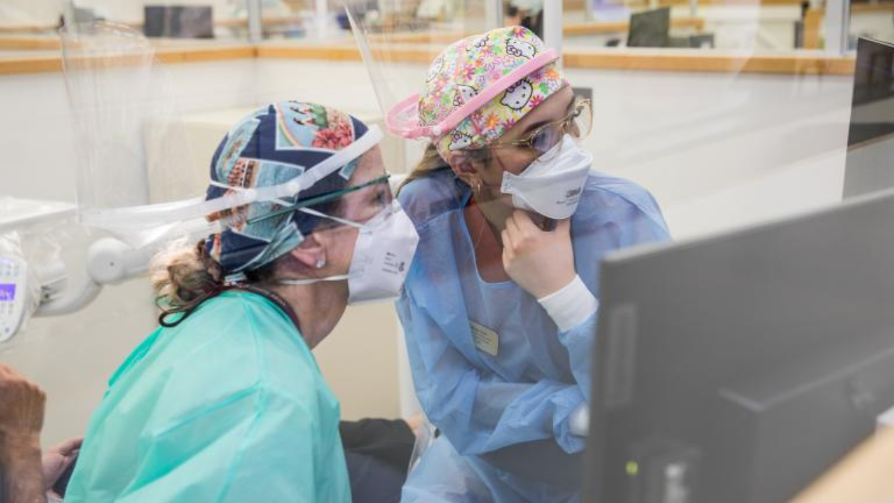 Two UCSF dentists look at a computer in the Dental Center