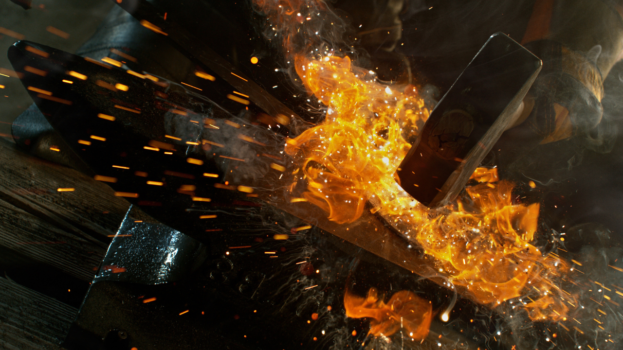 ironworking tools striking with flames