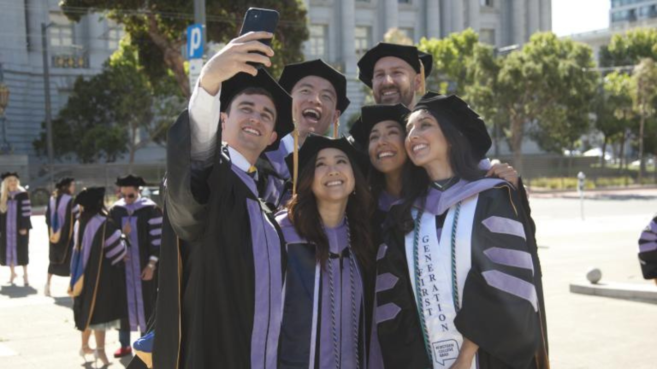 a group of UCSF Dentistry graduates take a selfie at the 2022 commencement ceremony