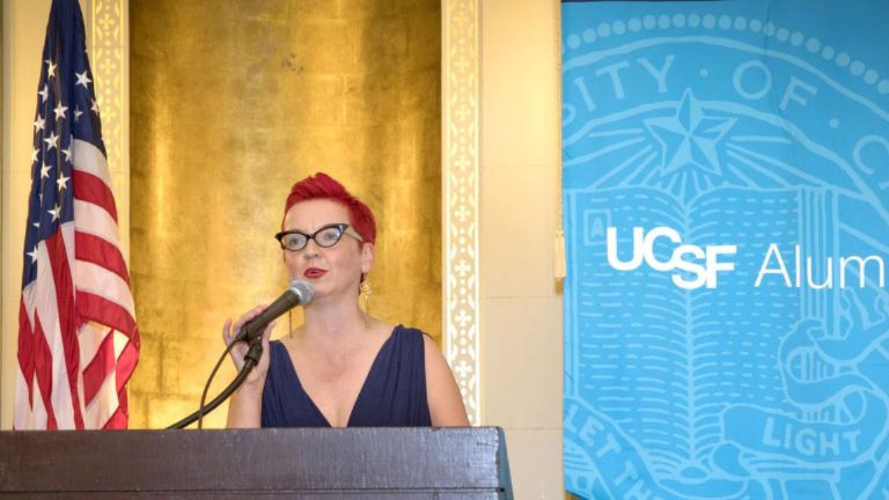 Sara Hughes at the podium giving a speech