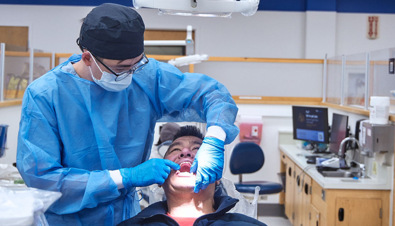 Student volunteer provides care to a patient at the UCSF Community Dental Clinic.