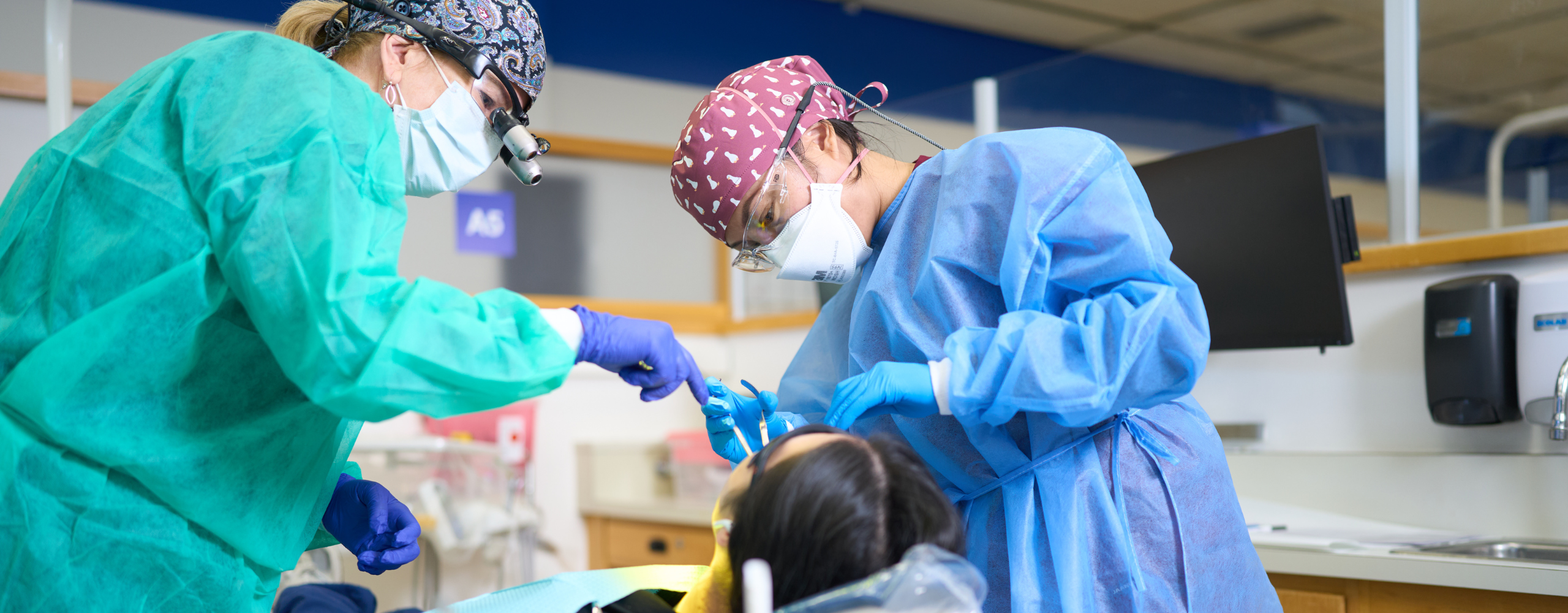 Community Dental Clinic faculty and student volunteers provide care to a patient.