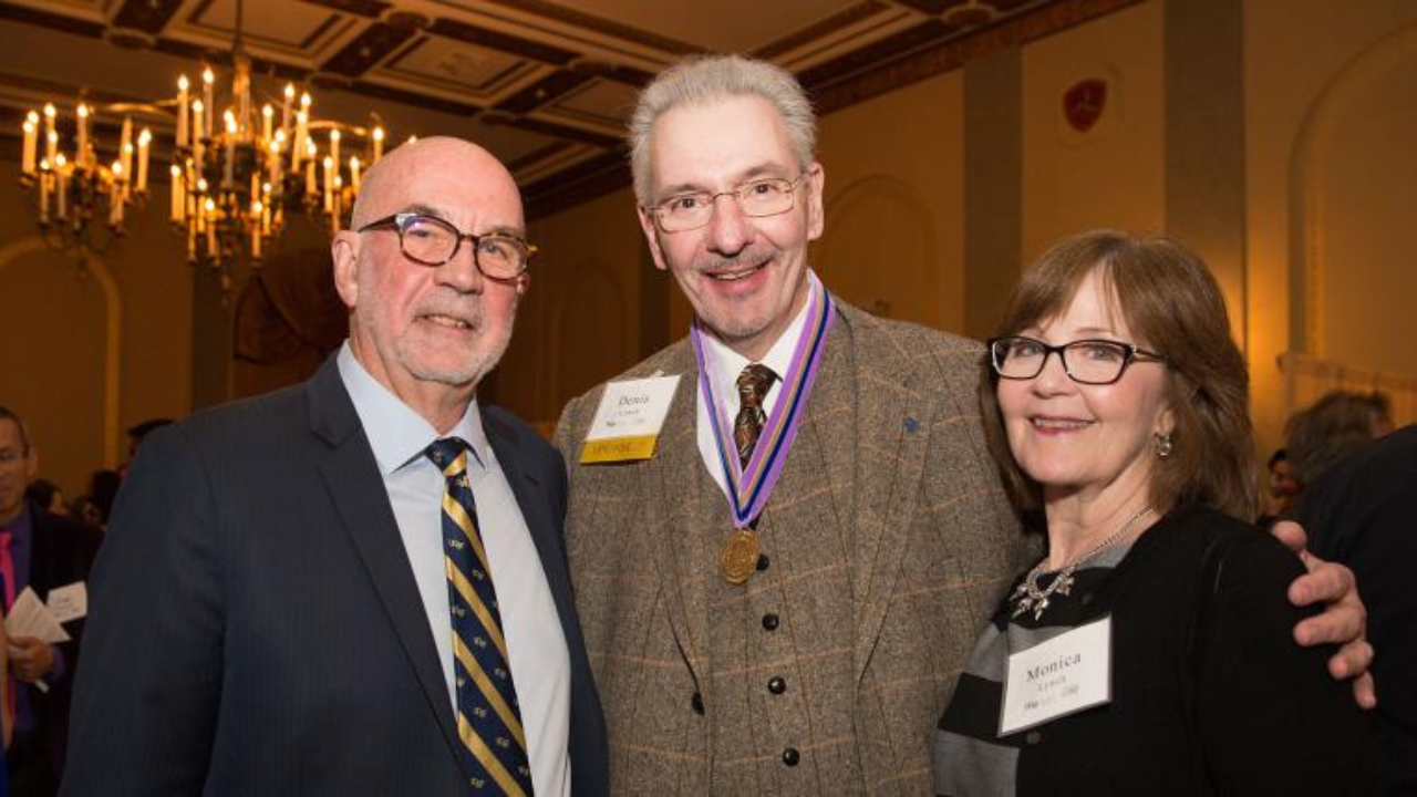 Denis Lynch (center) with wife and Dean Featherstone