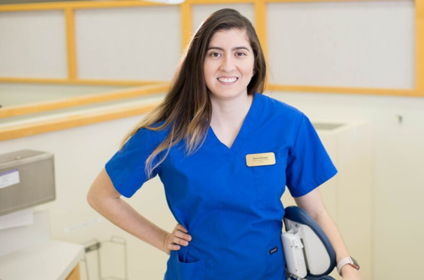 UCSF DDS student sees patients in her station at the Dental Center