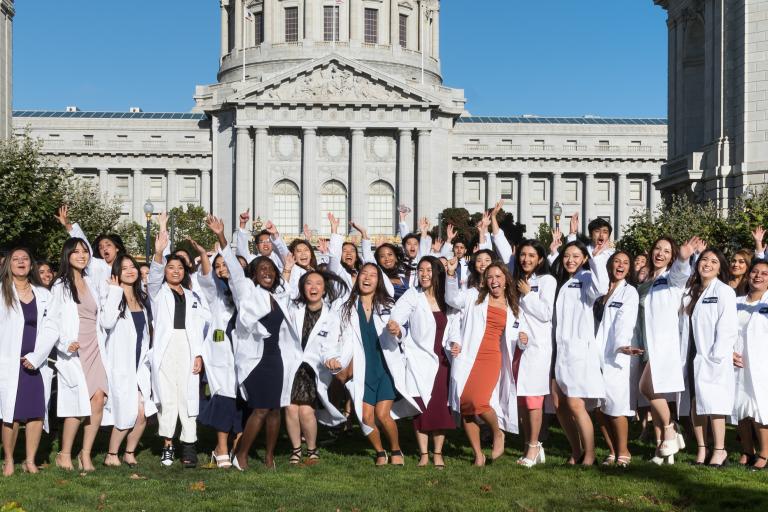 White coat recipients taking a group photo outside Herbst Theatre, celebrating the start of their journey at UCSF Dentistry