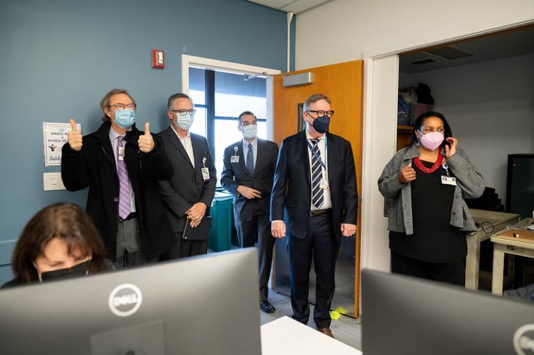 UCSF Dentistry Dean Michael Reddy (center) and Associate Dean Eunice Stephens (right) provide UCSF leaders with a tour of the command center set up to support Dentistry’s launch of the Epic electronic health record on December 5, 2022.