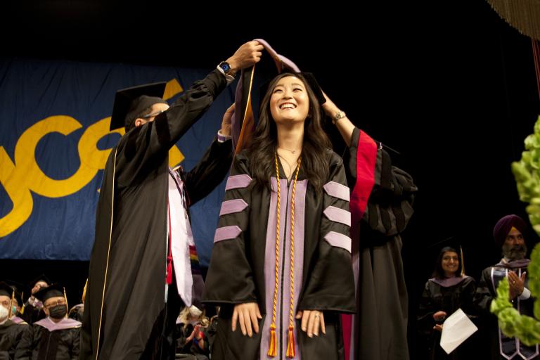 Dr. Hanna Kim being hooded at commencement. 