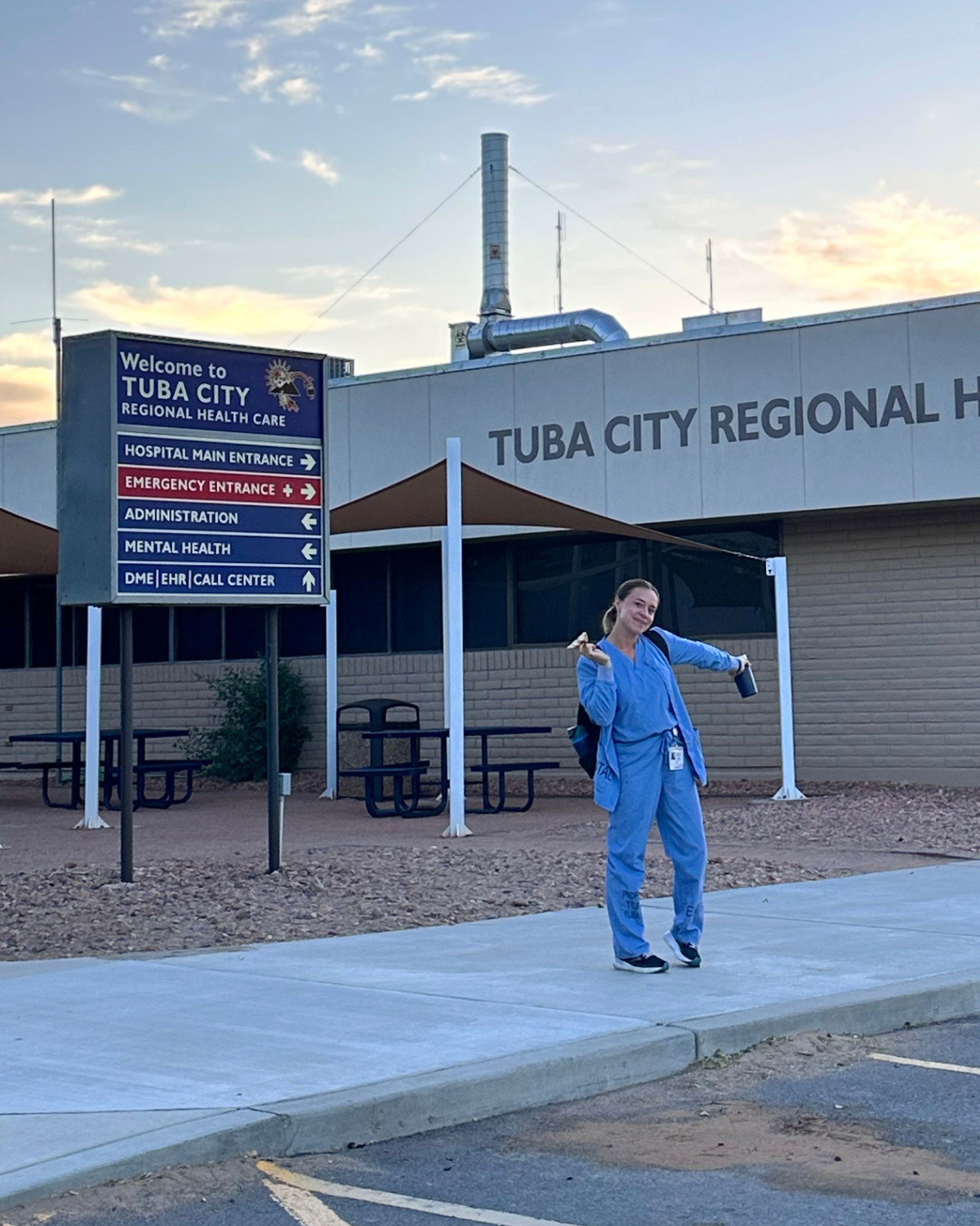 Emma Nedley stands outside the Tuba City Regional Health Care center at sunrise