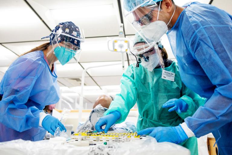 Ana Casal, DDS, associate professor and one of UCSF Dentistry's group practice leaders, works with two students to care for a patient.