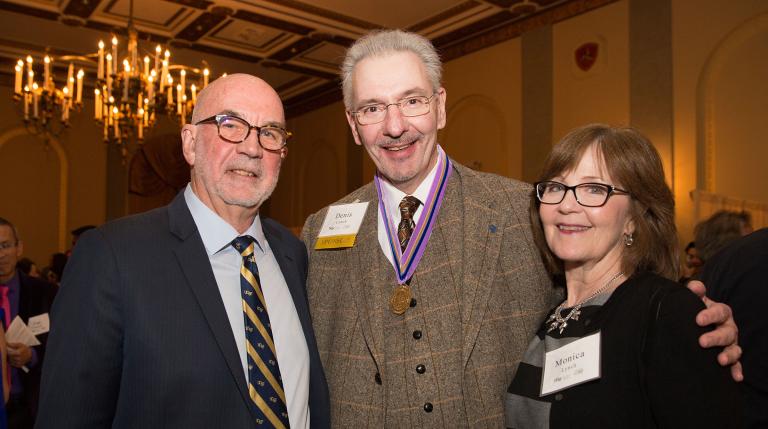 Dr. Denis Lynch (center) and his wife, Monica, with Dean Emeritus John D.B. Featherstone at the 2017 student graduation banquet (Photo by Elisabeth Fall)