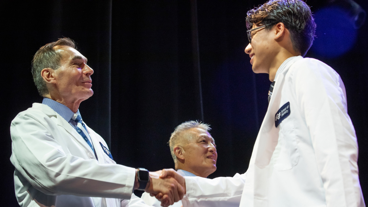 Dean Reddy congratulates Nicholas Ha, DDS Class of 2029