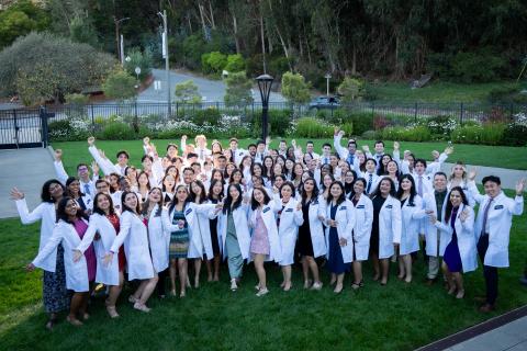 Students take group photo at white coat ceremony 2024