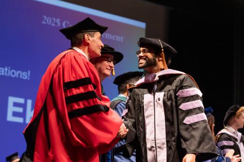 Dentistry graduate shaking hands with Dean Reddy
