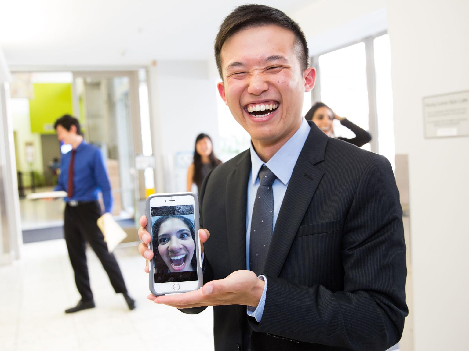 student holding phone