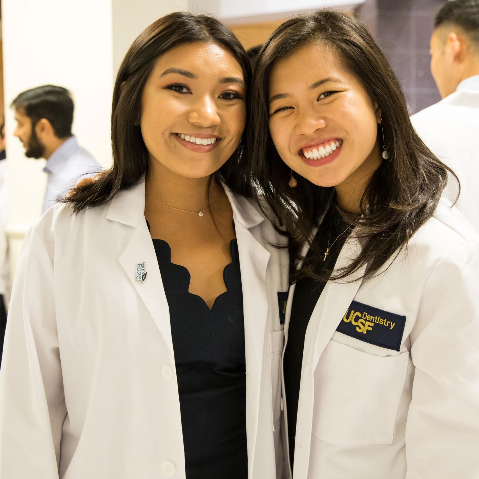 two students in lab coats