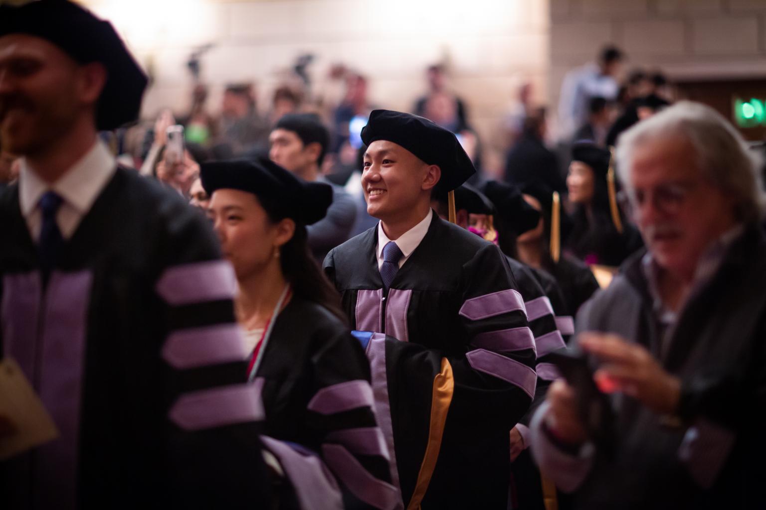 Graduate smiling during the processional 