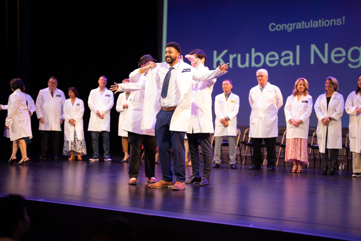 student coated at white coat ceremony