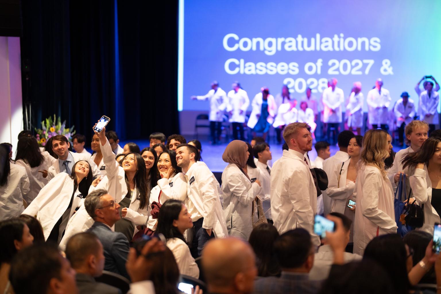 Students posing for selfie after receiving their White Coats