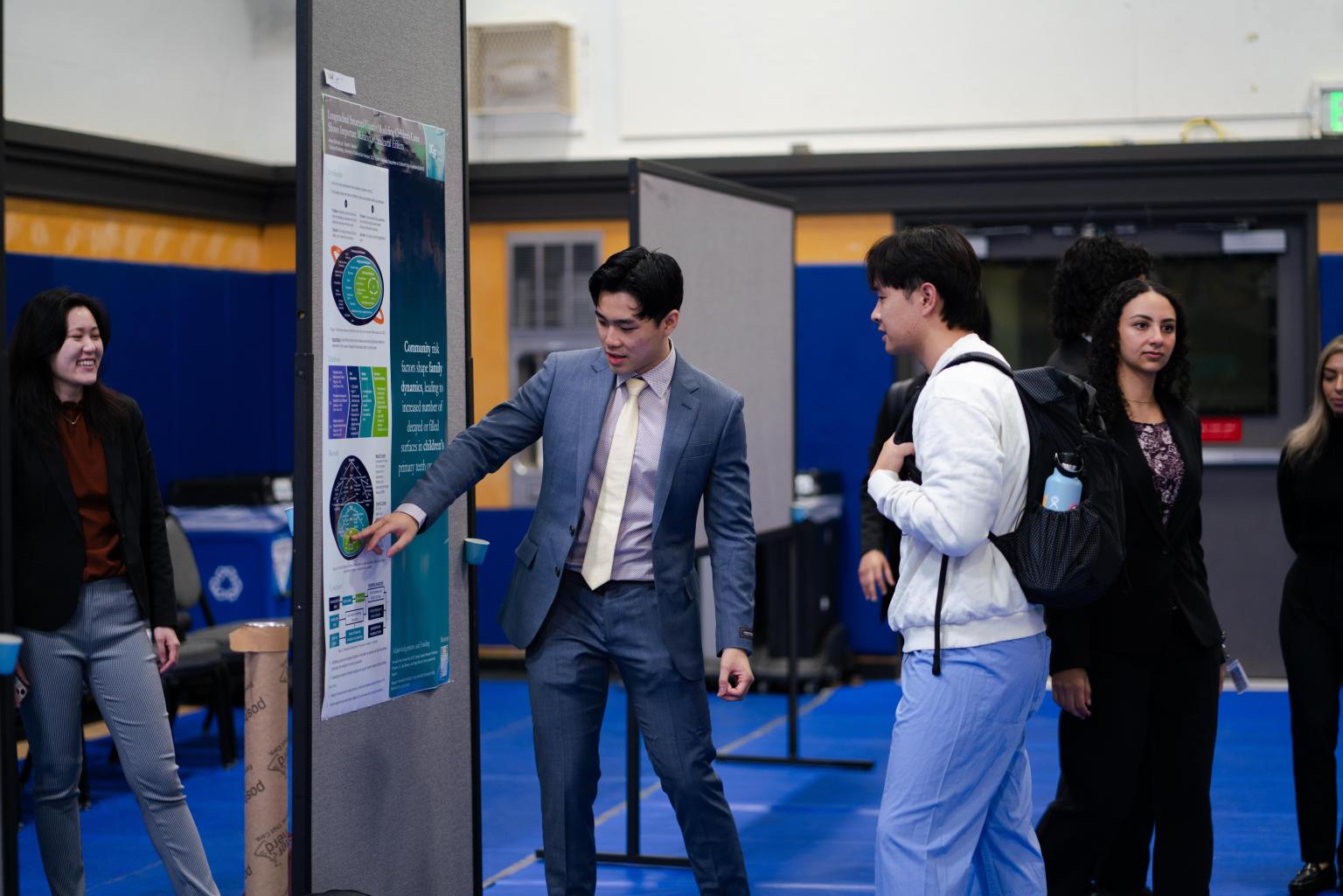 Dental student Ansen Lai presenting his project on the sociocultural effects of children's caries